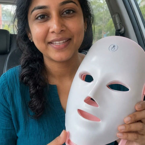 woman using led light therapy mask in her car
